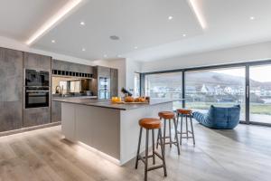 a kitchen with a island with bar stools at 5 Bed in Mortehoe oc-c30855 in Mortehoe