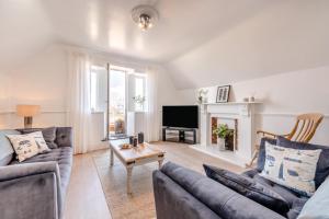 a living room with two couches and a tv at 3 Bed in Woolacombe oc-d32422 in Woolacombe
