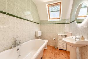a bathroom with a tub and a sink at 3 Bed in Woolacombe oc-d32422 in Woolacombe +17 photos