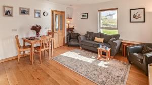 a living room with a couch and a table at 2 Bed in Reef oc-r30133 in Uig