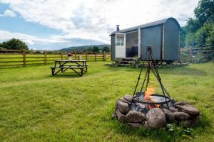 a fire pit with a tent in a field at 1 Bed in Talybont-on-Usk oc-a29348 in Talybont