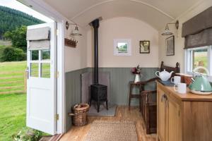 a kitchen with an open door and a stove at 1 Bed in Talybont-on-Usk oc-a29348 in Talybont