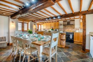 a kitchen and dining room with a wooden table and chairs at 4 Bed in Heywood oc-t29040 in Westbury