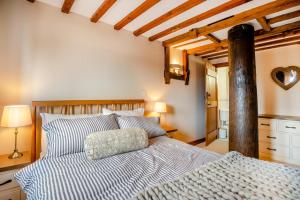 a bedroom with a bed with blue and white sheets at 4 Bed in Heywood oc-t29040 in Westbury