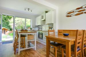a kitchen with a wooden table and a dining room at 2 Bed in Kelling oc-1716 in Kelling