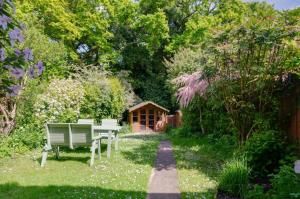 a bench sitting in the middle of a garden at 2 Bed in Kelling oc-1716 in Kelling