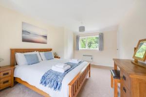a bedroom with a large white bed and a window at 2 Bed in Kelling oc-1716 in Kelling