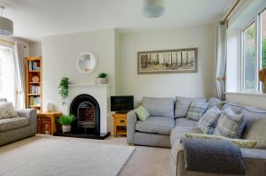 a living room with a couch and a fireplace at 2 Bed in Kelling oc-1716 in Kelling