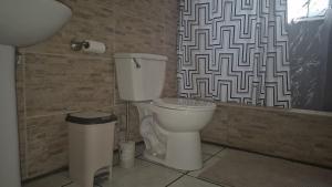 a bathroom with a toilet and a shower curtain at The Cupid Chalet Suite in Kingstown +20 photos