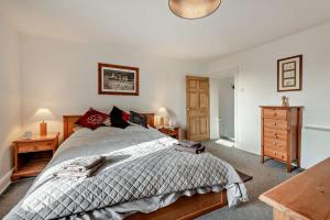 a bedroom with a bed and a wooden dresser at 3 Bed in Bowness-on-Solway oc-p28797 in Bowness-on-Solway
