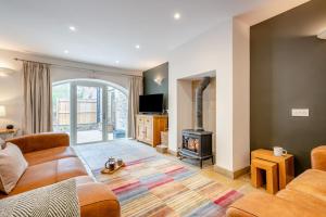 a living room with a couch and a wood stove at 2 Bed in Crakehall oc-m30355 in Crakehall