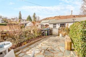a backyard with a stone walkway and a fence at 2 Bed in Braithwaite oc-p31730 in Braithwaite