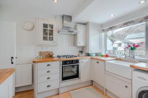 a kitchen with white cabinets and a sink at 2 Bed in Braithwaite oc-p31730 in Braithwaite +9 photos