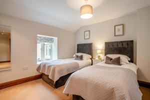 a bedroom with two beds and a window at 2 Bed in Crakehall oc-m30355 in Crakehall