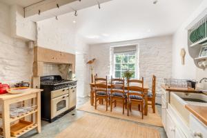 a kitchen with a table and chairs and a stove at 4 Bed in Matlock Bath oc-r32432 in Matlock Bank