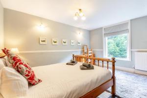 a bedroom with a bed and a window at 4 Bed in Matlock Bath oc-r32432 in Matlock Bank