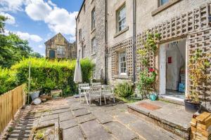 a patio with a table and an umbrella next to a building at 4 Bed in Matlock Bath oc-r32432 in Matlock Bank