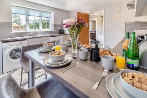 a kitchen with a table with food and flowers on it at 2 Bed in Oxborough oc-r29291 in Oxborough