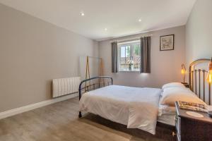 a bedroom with a bed and a table and a window at 2 Bed in Oxborough oc-r29291 in Oxborough