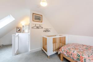 a white bedroom with a bed and a crib at 2 Bed in Battle oc-c31781 in Battle