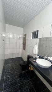 a bathroom with a sink and a toilet at Ilka in Barreirinhas