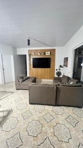 a living room with a couch and a flat screen tv at Ilka in Barreirinhas