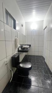 a bathroom with a toilet and a sink at Ilka in Barreirinhas