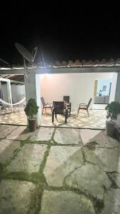 a patio at night with chairs and a piano at Ilka in Barreirinhas