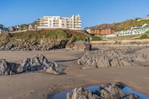 a view of a beach with rocks and a building at 2 Bed in Langland oc-f30206 in Newton