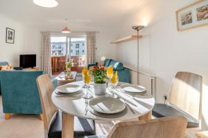 a dining room with a white table and chairs at 2 Bed in Langland oc-f30206 in Newton