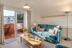 a living room with a blue couch and a table at 2 Bed in Langland oc-f30206 in Newton +4 photos