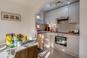 a kitchen with white cabinets and a counter top at 2 Bed in Langland oc-f30206 in Newton