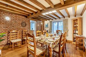 a dining room with a table and chairs and a brick wall at 4 Bed in Litcham oc-h30106 in Litcham