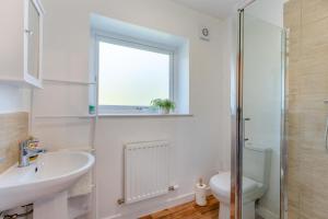 a bathroom with a sink and a toilet and a window at 3 Bed in Coldingham oc-b29846 in Coldingham +17 photos