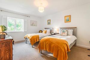 a bedroom with two beds and a dresser at 3 Bed in Longtown oc-h30069 in Longtown