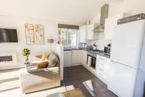 a kitchen with white cabinets and a couch in a room at 2 Bed in Felton oc-w30642 in Felton +8 photos
