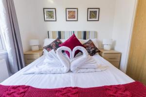 two white swansuitsrendered to look like they are on a bed at 2 Bed in Felton oc-w30642 in Felton