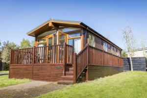 a large wooden house with a large deck at 2 Bed in Felton oc-w30642 in Felton