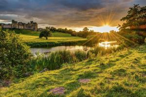 a sunset over a river with a castle in the background at 2 Bed in Felton oc-w30642 in Felton