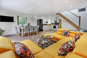 a living room with a yellow couch and a table at 4 Bed in Retorrick Mill oc-w28897 in Saint Mawgan