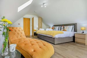 a bedroom with a bed and a couch at 4 Bed in Retorrick Mill oc-w28897 in Saint Mawgan