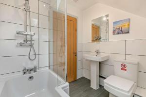 a bathroom with a tub and a sink and a toilet at 4 Bed in Retorrick Mill oc-w28897 in Saint Mawgan +24 photos