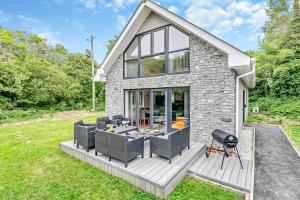 a stone house with a patio and a grill at 4 Bed in Retorrick Mill oc-w28897 in Saint Mawgan