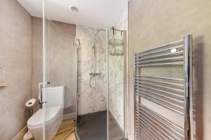a bathroom with a toilet and a glass shower at 1 Bed in Berriew oc-a31113 in Berriew +15 photos