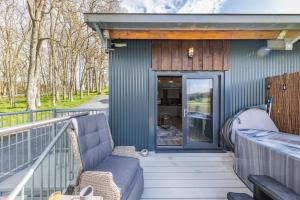 a blue house with a couch on a balcony at 1 Bed in Berriew oc-a31113 in Berriew