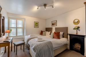 a bedroom with two beds and a fireplace at 2 Bed in Field Broughton oc-l31021 in Cartmel