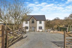 an exterior view of a house with a fence at 5 Bed in Ystrad Meurig oc-r31133 in Ystrad Meurig