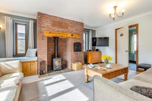 a living room with a brick fireplace at 5 Bed in Ystrad Meurig oc-r31133 in Ystrad Meurig