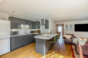 a kitchen and living room with a couch and a table at 2 Bed in West Quantoxhead oc-p30893 in West Quantoxhead