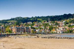 a view of a beach with a town in the background at 2 Bed in West Quantoxhead oc-p30893 in West Quantoxhead